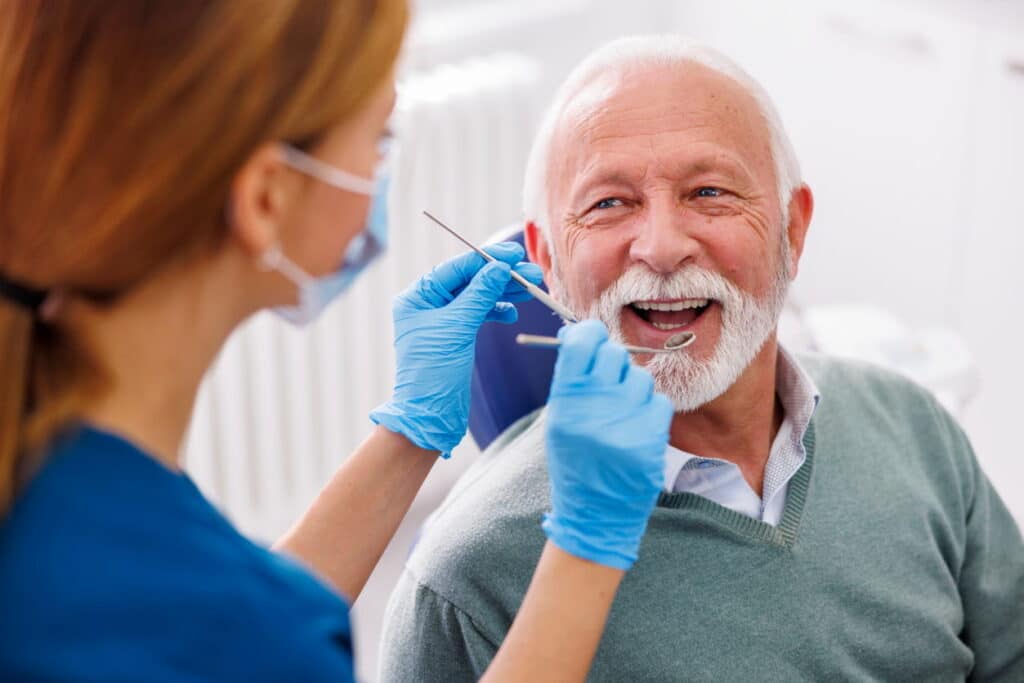 A patient smiling at his dentist in a Summerlin dental office.