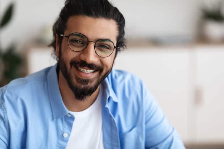 A man smiling with braces.