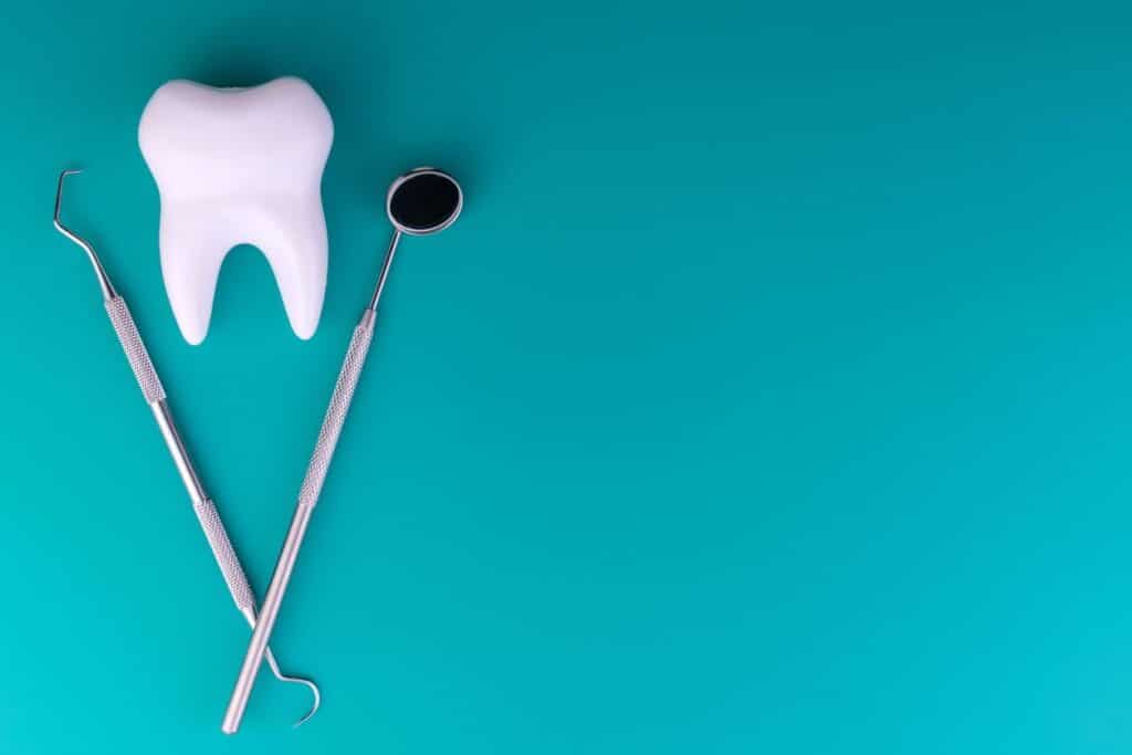 A photo of a tooth and two dental tools from a general dentist in henderson, nv.