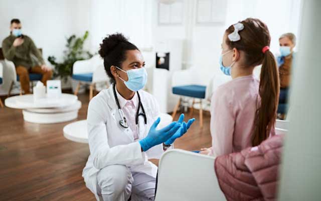 Dentist talking to child patient