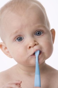 baby trying to brush teeth