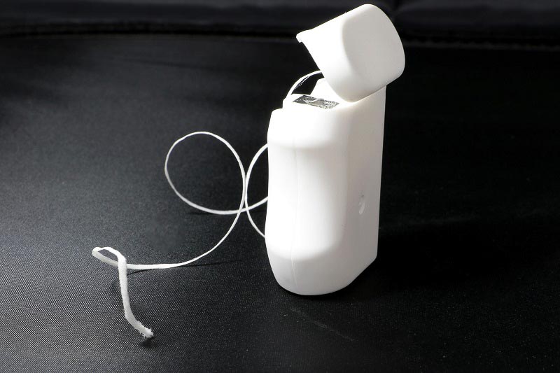 Dental floss in container