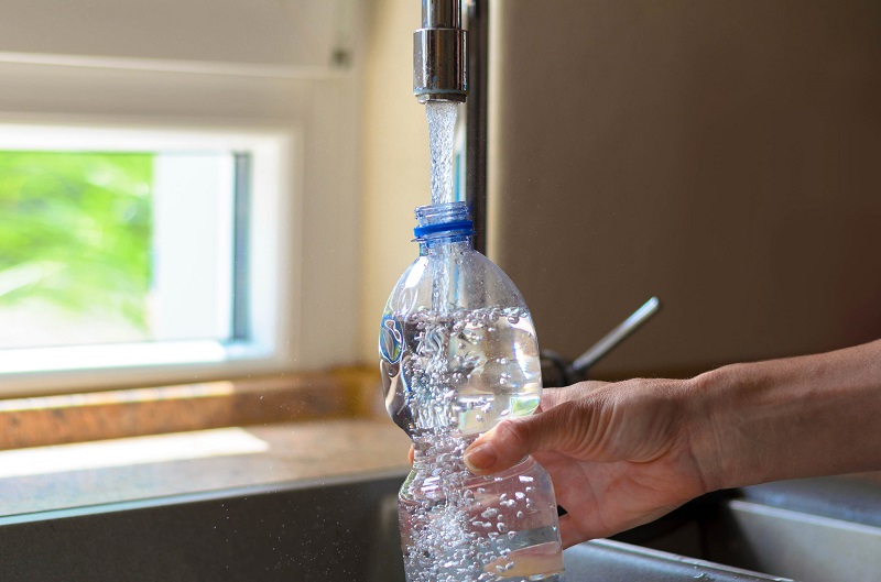 Pouring water into bottle