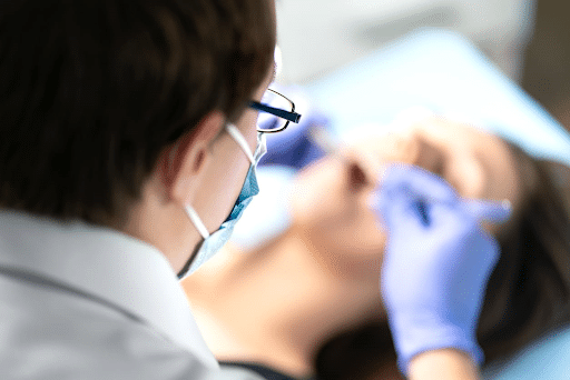 A dentist removing wisdom teeth from their patient. 