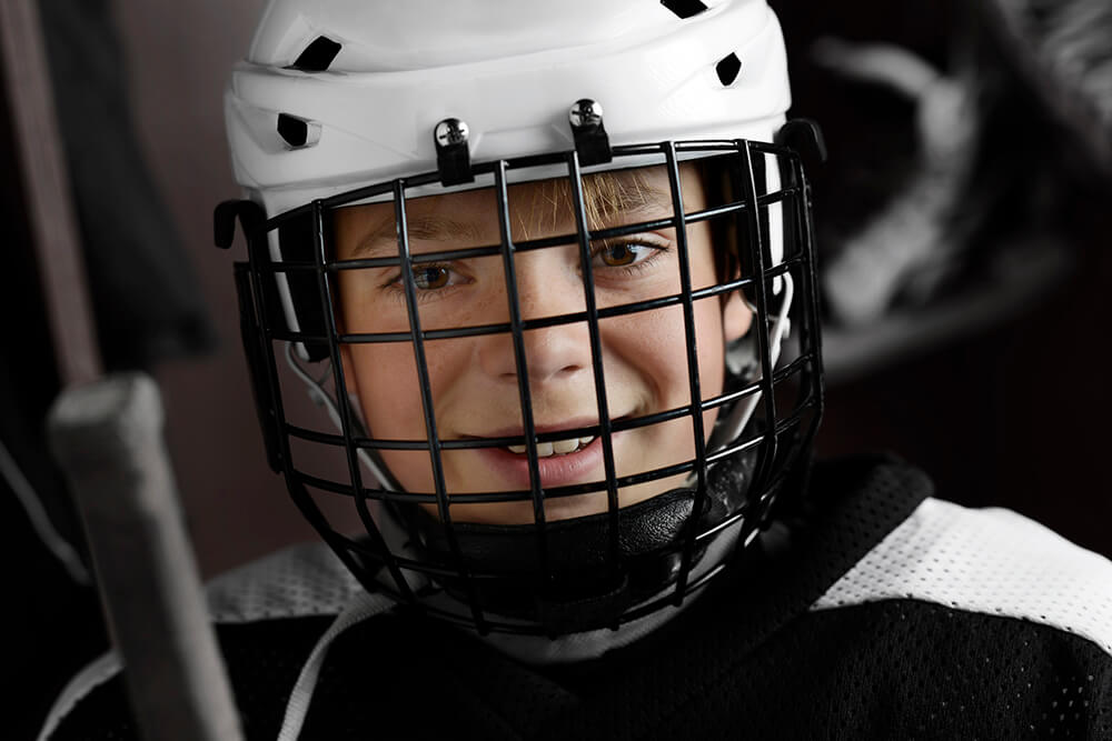 Child wearing hockey head gear