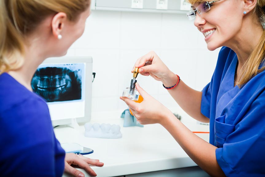 dentist showing dental implants