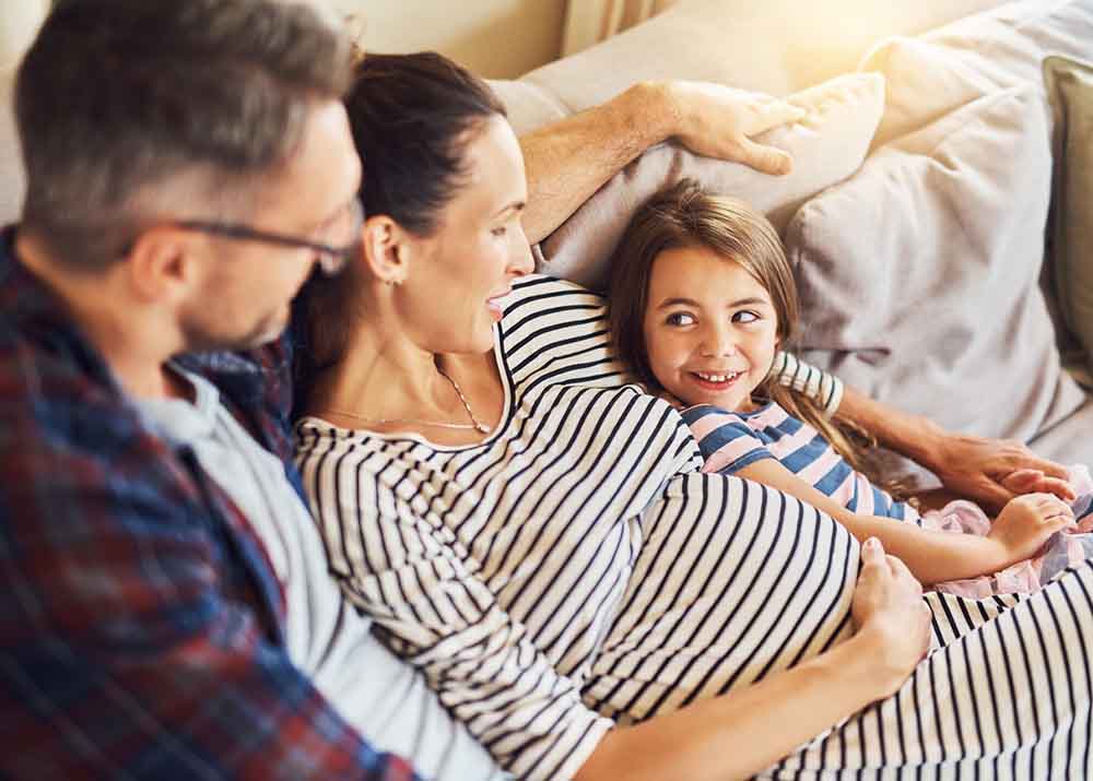 family relaxing on the couch