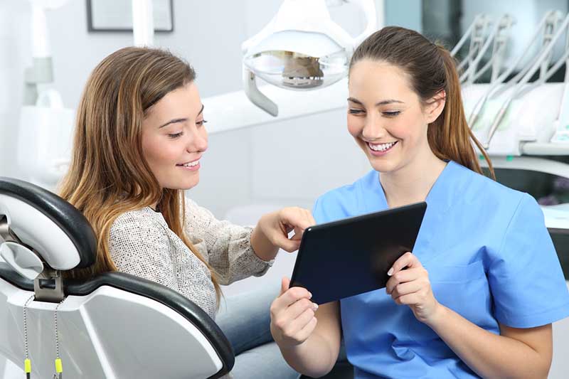 Talking with dentist after wisdom teeth extraction