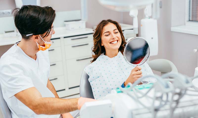 Woman smiling after getting dental implant