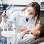 Dentist showing child x-ray