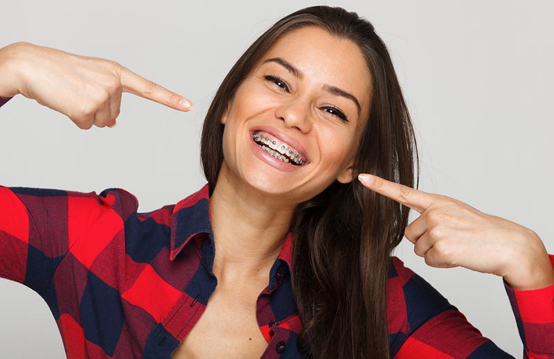 woman smiling with metal braces