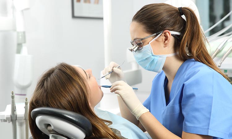 Woman getting teeth examined