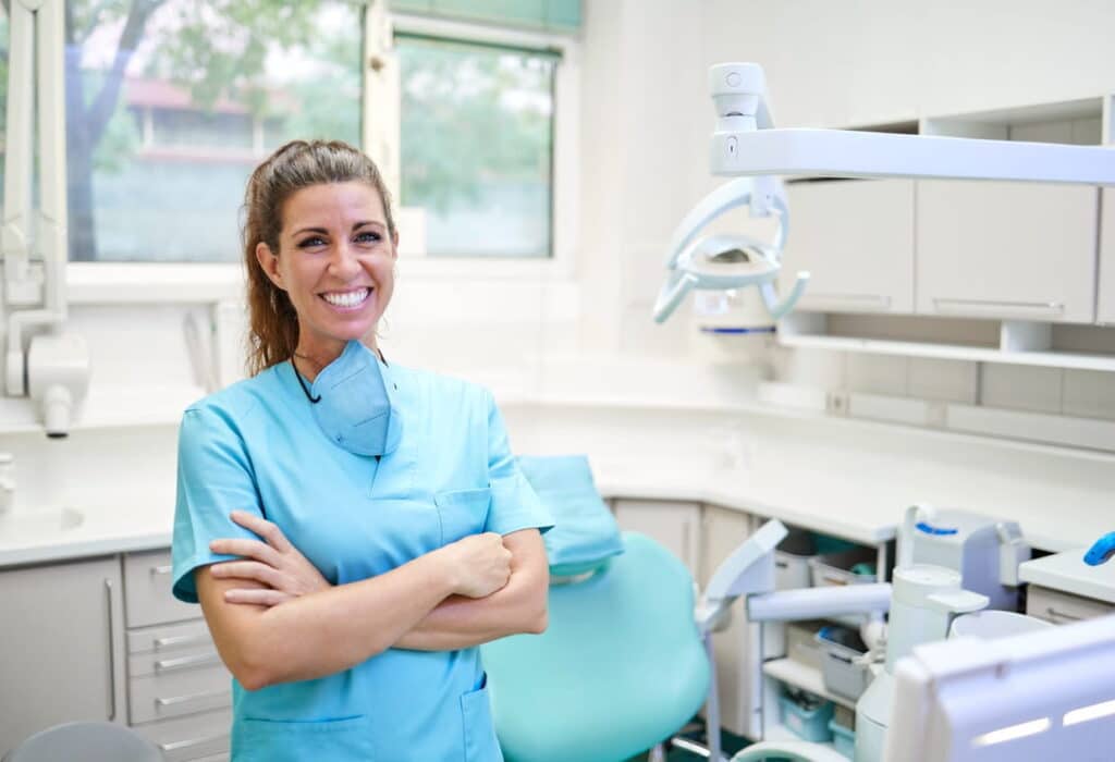 A doctor smiling after completing a wisdom tooth extraction.