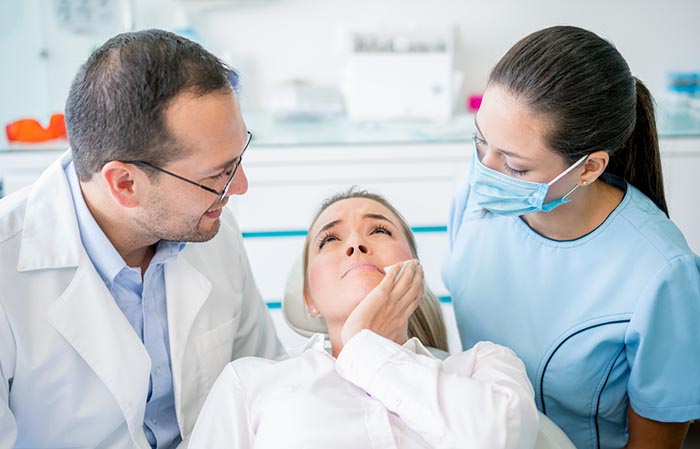 Woman with sensitive teeth at dentist