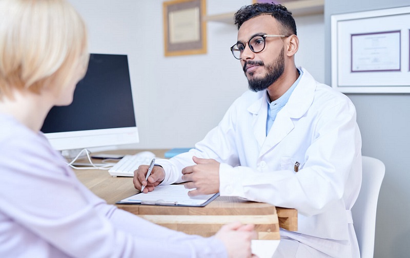 A Patient Speaking with a Dentist