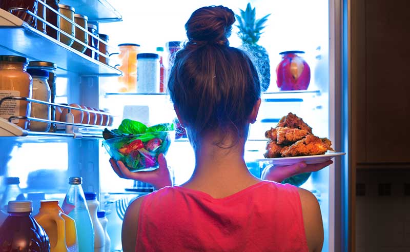 Woman looking in fridge