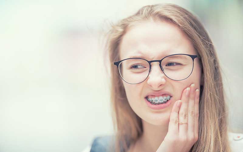 Girl in pain from braces