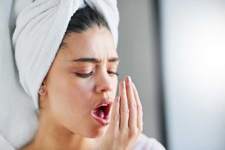 Woman checking her breath 