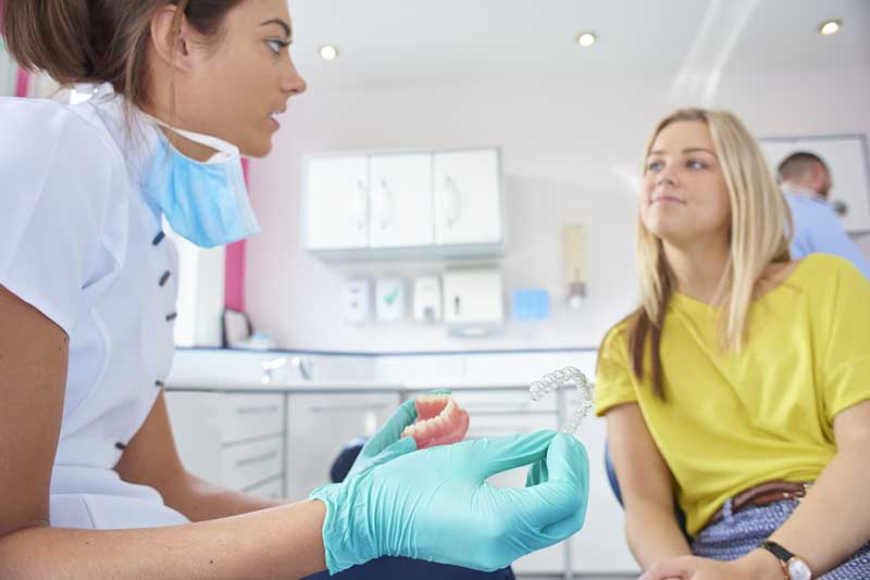 patient talking to orthodontist 