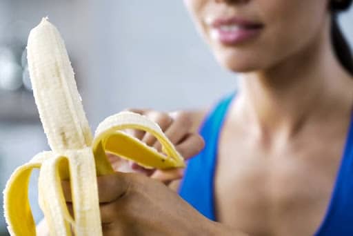 woman with braces eating a banana