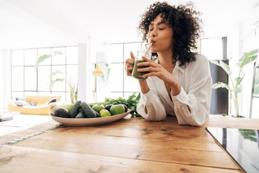 Woman drinking a smoothie to protect her new braces
