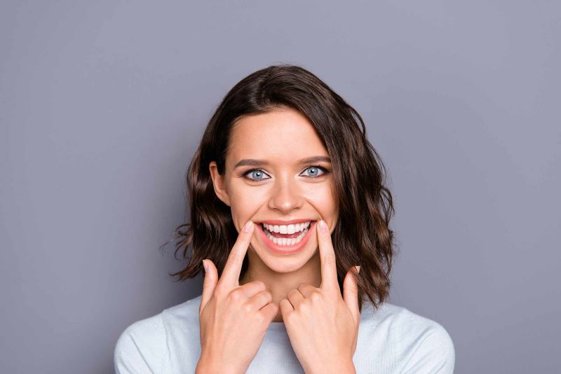 A girl smiling after a cosmetic teeth whitening treatment in Carson City