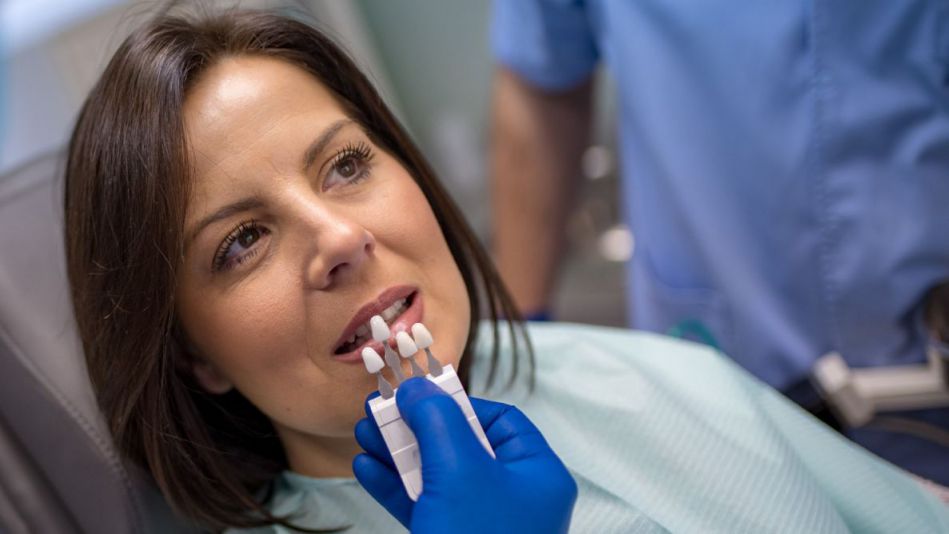 Dentist testing out dental crown options for female patient in Carson city