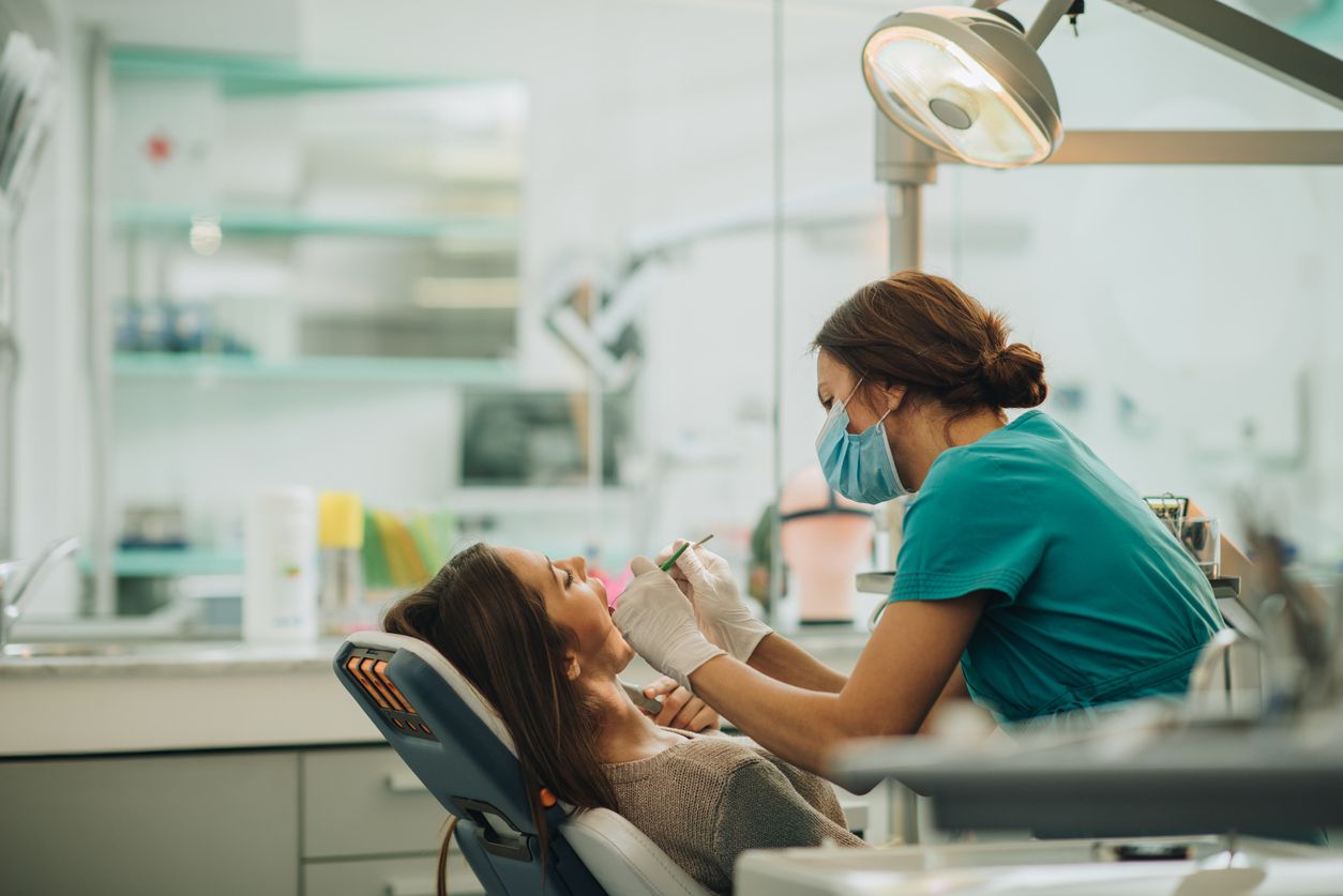 Young woman having her teeth checked by a metal free dentist