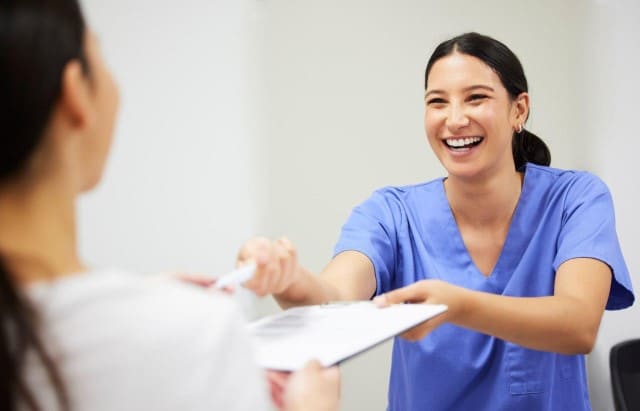 Dentist giving Paperwork to Patient