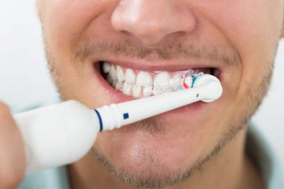 A man using an electric toothbrush