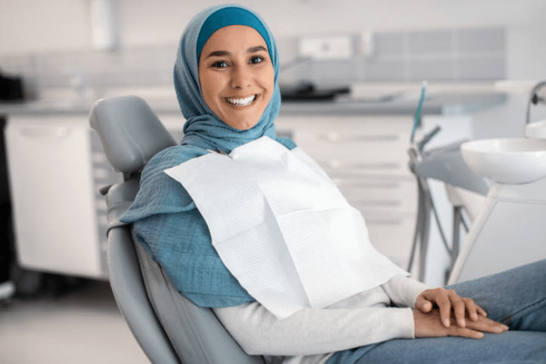 a woman smiling while in a dentist's chair