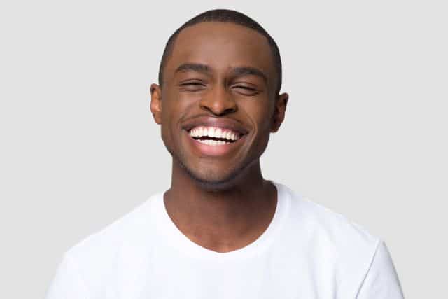 man smiling after getting his teeth whitened at Absolute Dental