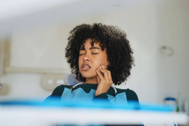 Woman at an emergency dentistry for her tooth pain