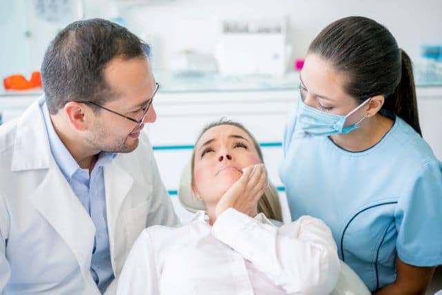 Patient getting abscessed tooth removed by emergency dentist