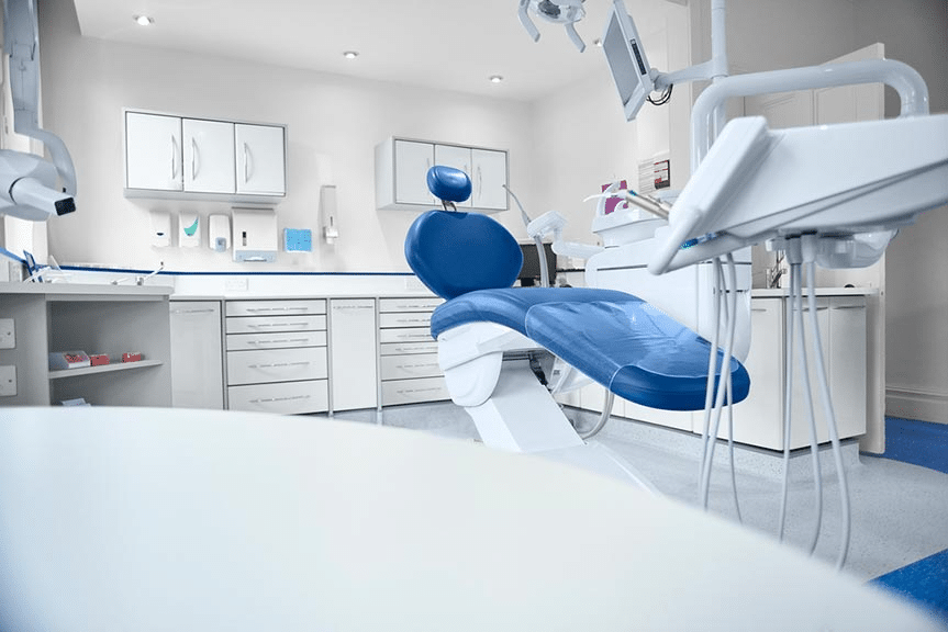 Image of dentist blue dentist chair in dentist office.
