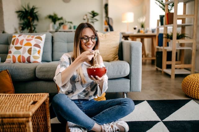 Woman eating soft pasta after getting veneers