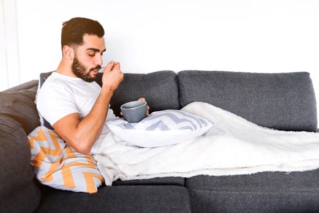 Man eating soup after oral surgery