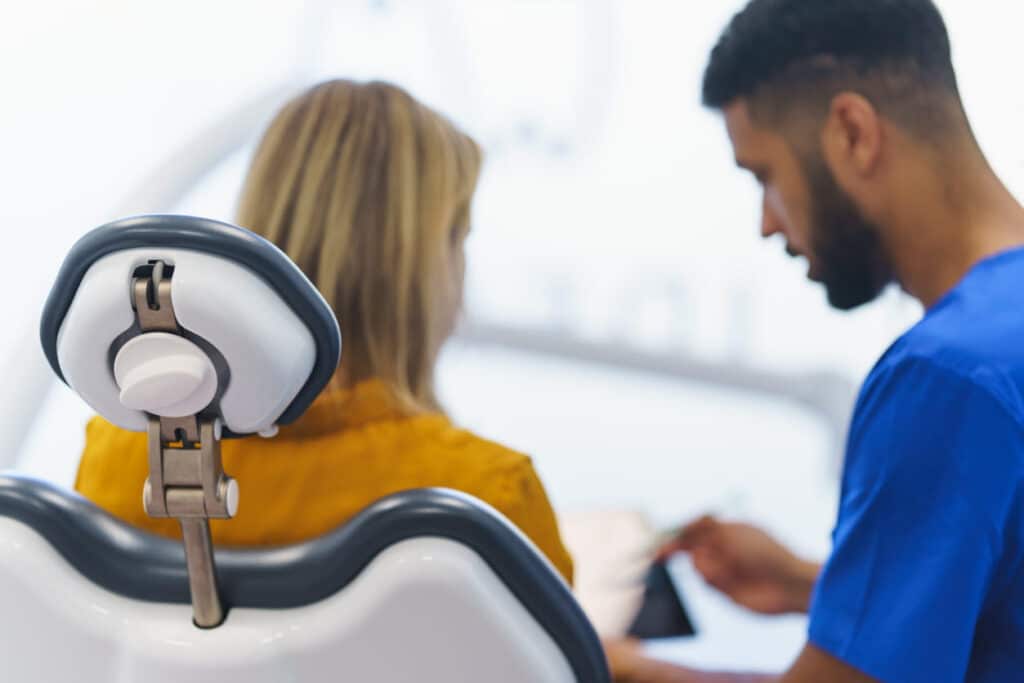 A side view of a family dentist in Las Vegas treating his patient