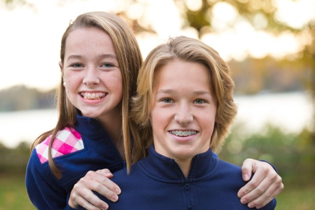 Two young kids smiling with braces