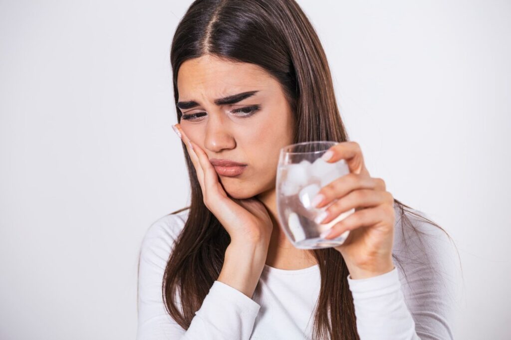 Woman with Sensitive Teeth and Iced Water