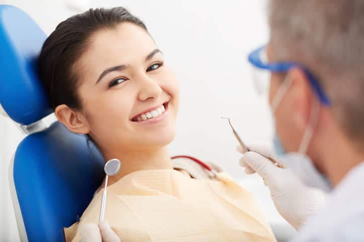 A woman smiling at the dentist's office