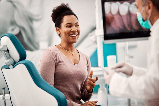 A patient smiling after finishing her dental appointment.