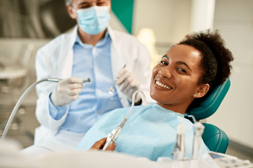 A woman smiling in sparks, nevada while receiving dental care.