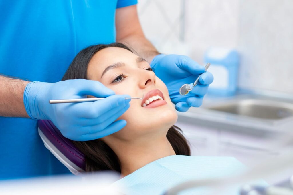 A general dentist working on his patient's teeth.