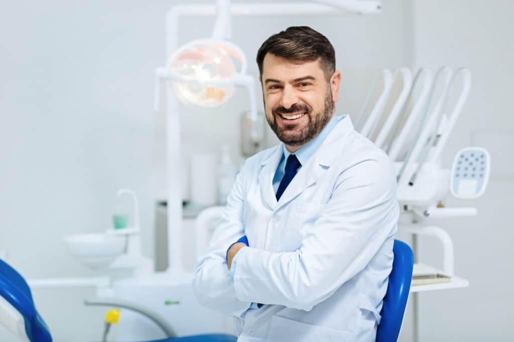 Welcoming Sedation Dentist in front of equipment