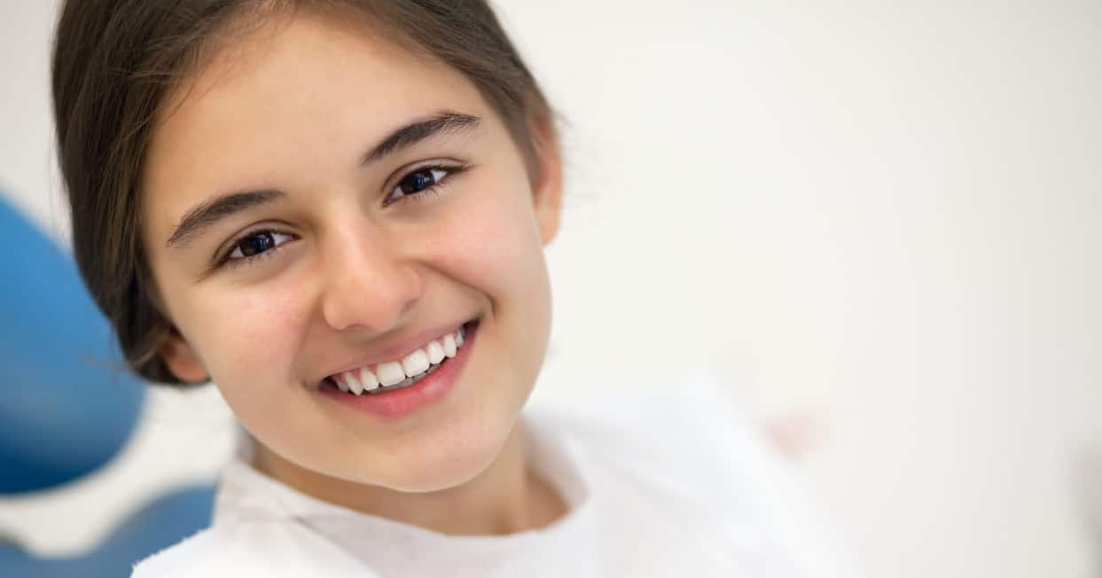 A girl smiling at the dentist's office