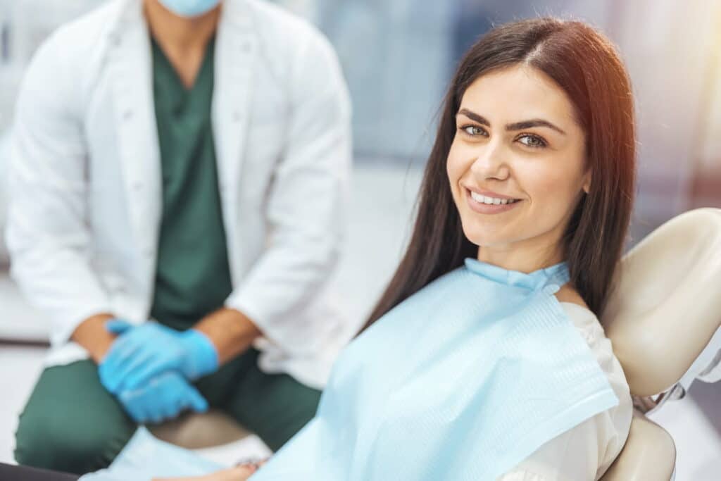 A woman in a dentist chair smiling in Sparks, NV.