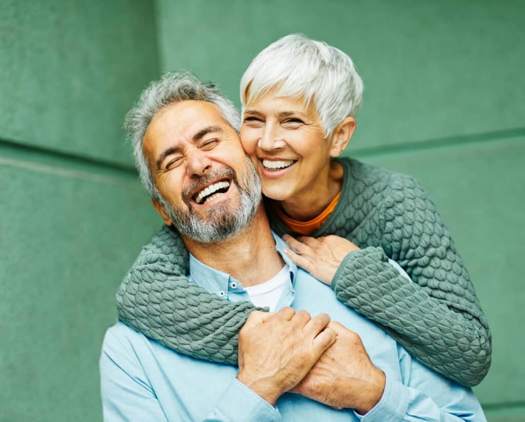 An older couple smiling together.