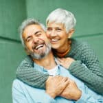 An older couple smiling together.