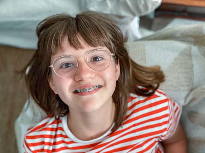 A child smiling with metal braces.